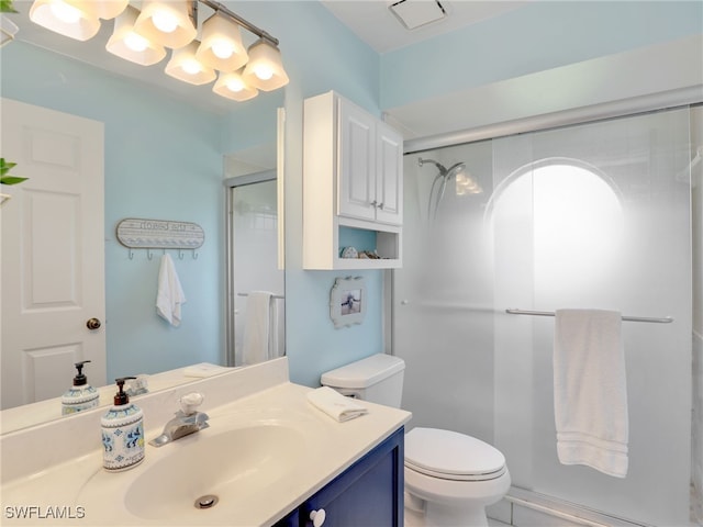 bathroom with vanity, toilet, and an enclosed shower