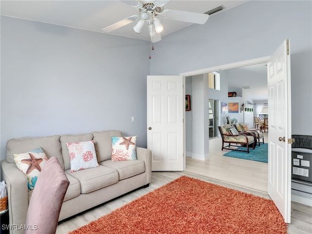 living room with ceiling fan and light hardwood / wood-style flooring