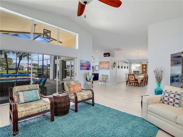 living room featuring hardwood / wood-style floors, ceiling fan, and lofted ceiling