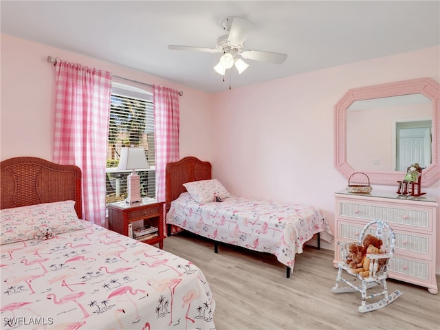 bedroom with ceiling fan and light hardwood / wood-style flooring