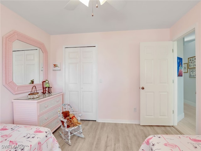 bedroom featuring ceiling fan, a closet, and light wood-type flooring