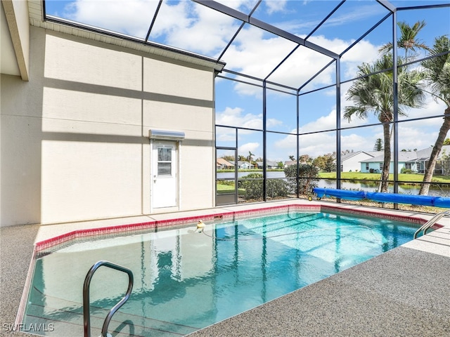 view of pool with glass enclosure