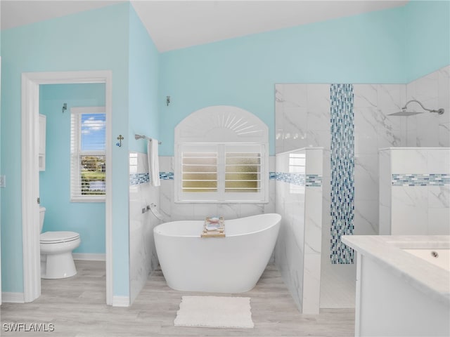 full bathroom featuring hardwood / wood-style floors, a wealth of natural light, and tile walls