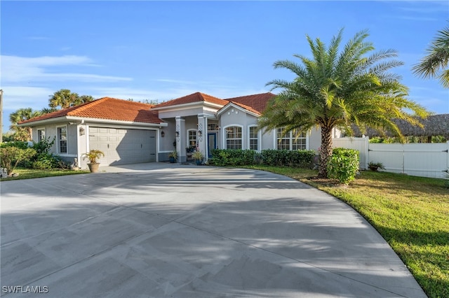 mediterranean / spanish-style house with a garage