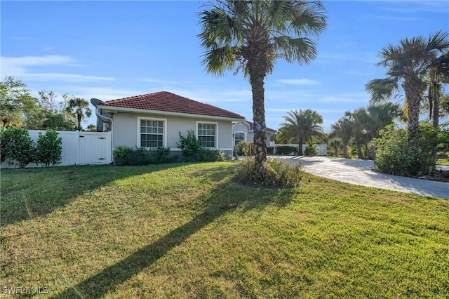 3930 24th Ave SE, Naples, FL 34117 - view of front of home featuring stucco siding, a gate, a tiled roof, and driveway