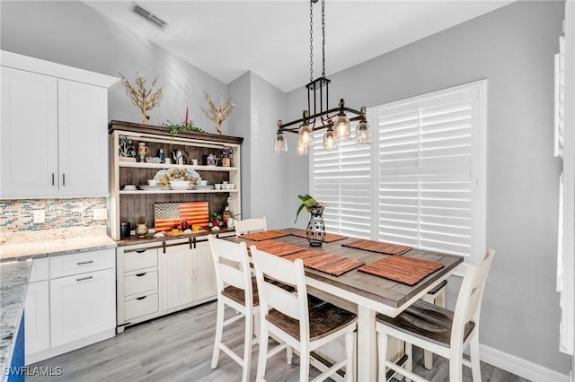 3930 24th Ave SE, Naples, FL 34117 - dining room with light wood-style floors and a chandelier