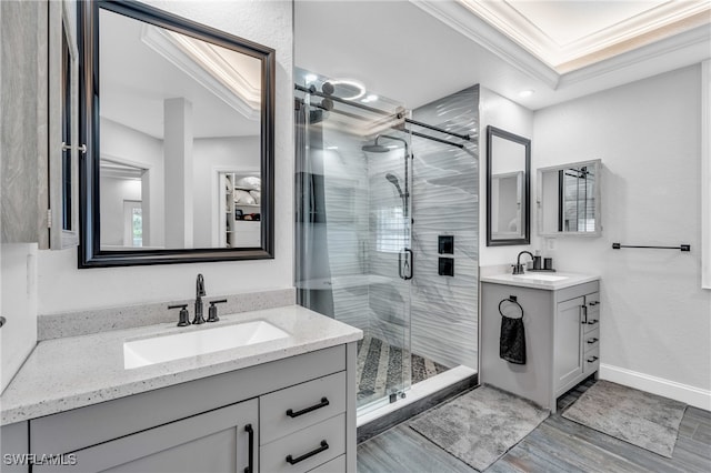 bathroom with vanity, wood-type flooring, ornamental molding, and walk in shower