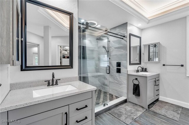 3930 24th Ave SE, Naples, FL 34117 - full bath with a stall shower, two vanities, crown molding, wood finished floors, and baseboards