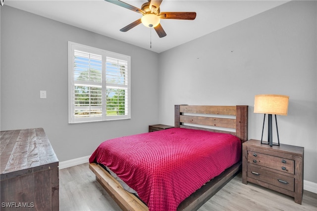 bedroom with ceiling fan and light hardwood / wood-style flooring