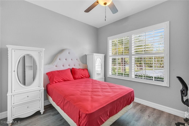 bedroom featuring ceiling fan and dark wood-type flooring