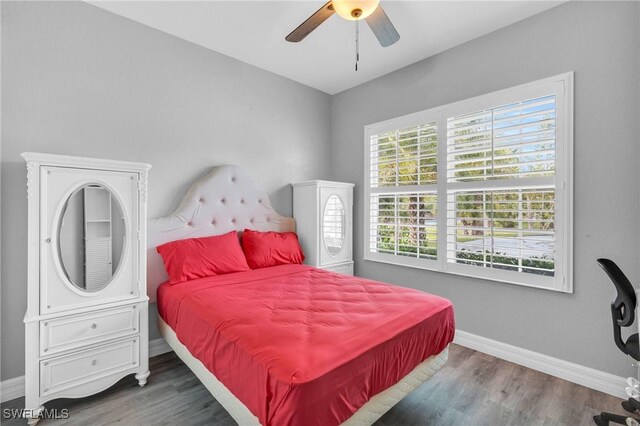 3930 24th Ave SE, Naples, FL 34117 - bedroom with baseboards, wood finished floors, and a ceiling fan
