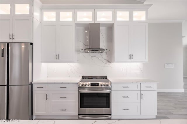 kitchen with white cabinetry, light stone countertops, island exhaust hood, decorative backsplash, and appliances with stainless steel finishes