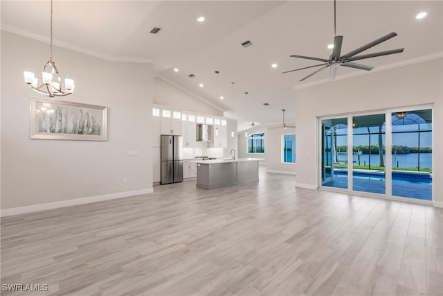 unfurnished living room featuring ornamental molding, ceiling fan with notable chandelier, sink, high vaulted ceiling, and light hardwood / wood-style floors