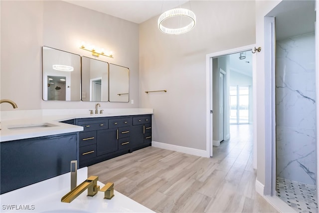 bathroom with vanity, wood-type flooring, and walk in shower