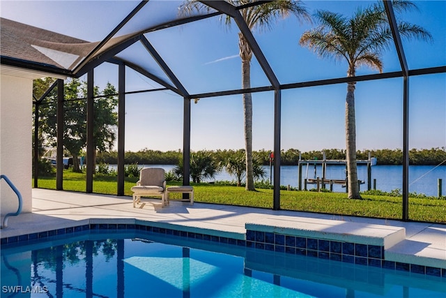 view of pool with a water view, glass enclosure, and a patio area