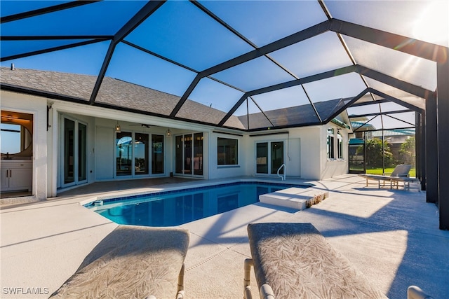 view of swimming pool with a patio, ceiling fan, and a lanai