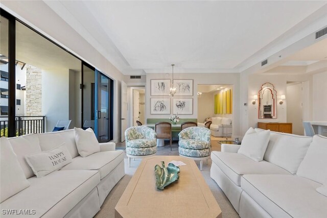 living room featuring a fireplace and a notable chandelier