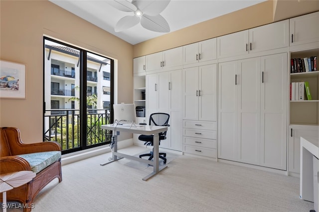 carpeted office featuring ceiling fan