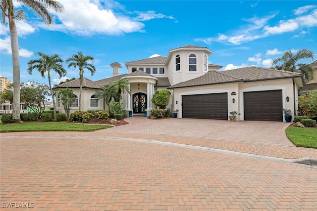 mediterranean / spanish-style home with a garage