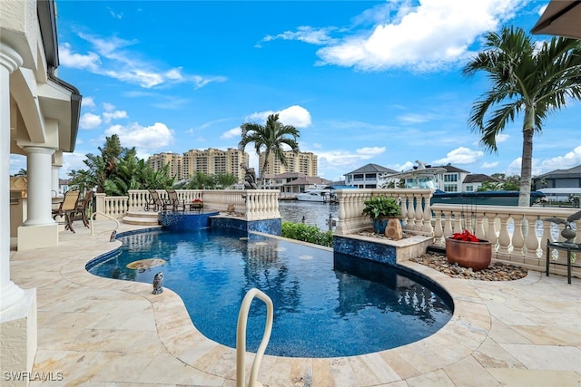 view of pool featuring a patio area and a water view