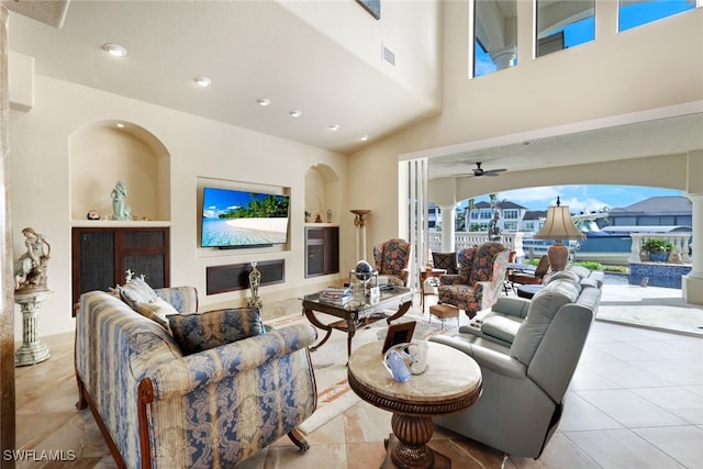 living room featuring light tile patterned floors, vaulted ceiling, and ceiling fan