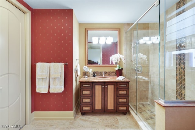 bathroom featuring tile patterned floors, a shower with door, and vanity