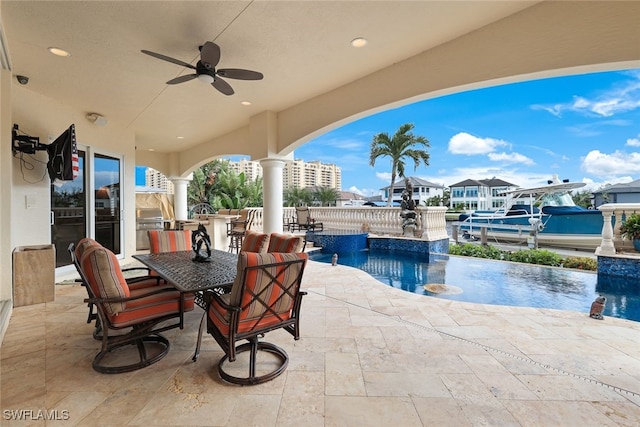 view of patio / terrace with pool water feature, ceiling fan, and an outdoor bar