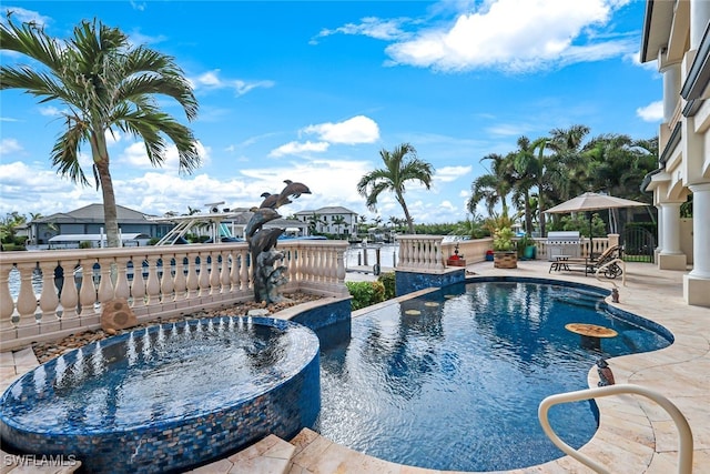 view of swimming pool featuring a patio and an outdoor kitchen