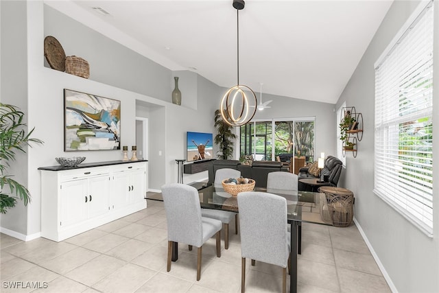 dining room with high vaulted ceiling, a notable chandelier, and light tile patterned flooring