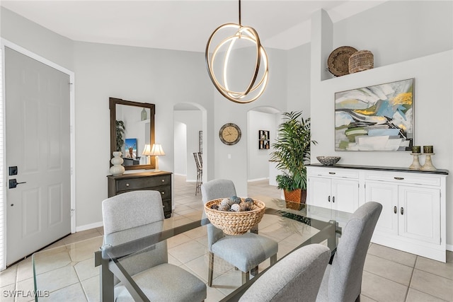 tiled dining area with vaulted ceiling