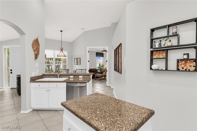 kitchen featuring a wealth of natural light, dishwasher, white cabinets, and vaulted ceiling