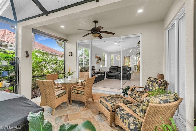 sunroom / solarium with lofted ceiling with beams and ceiling fan