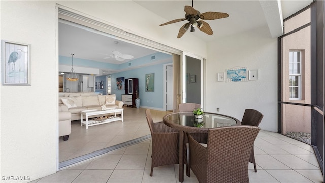 sunroom featuring ceiling fan