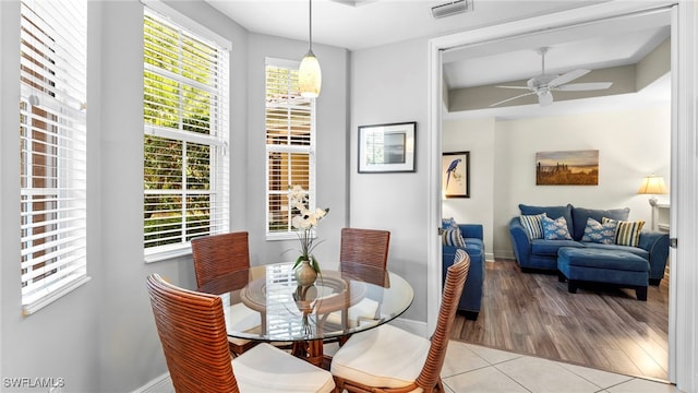 dining area with ceiling fan and light tile patterned floors