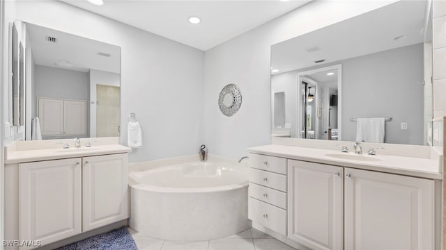 bathroom featuring vanity, tile patterned floors, and a bathing tub