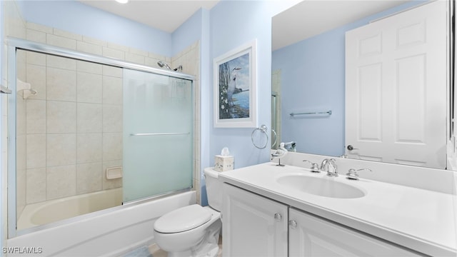 full bathroom featuring shower / bath combination with glass door, vanity, and toilet