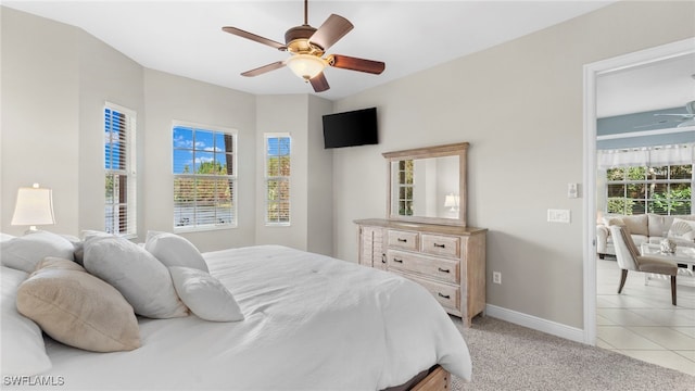 bedroom featuring light colored carpet and ceiling fan