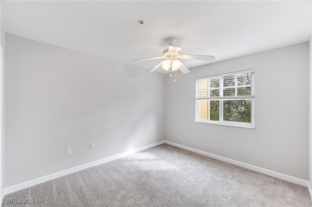 empty room with ceiling fan and carpet floors