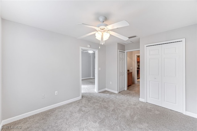 unfurnished bedroom featuring ceiling fan and light carpet