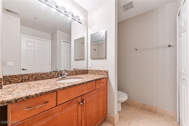 bathroom featuring tile patterned floors, vanity, and toilet