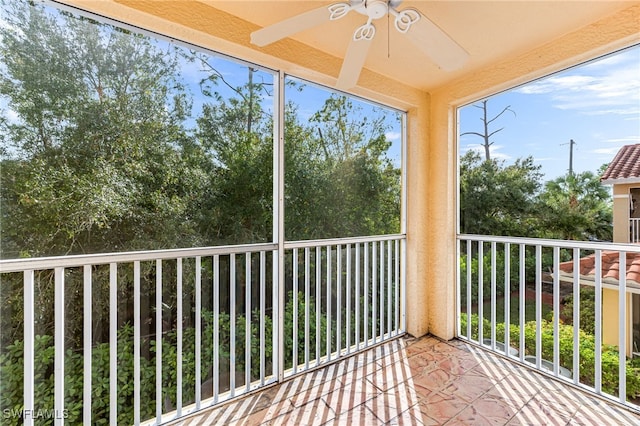 unfurnished sunroom with ceiling fan