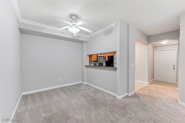 unfurnished living room with light colored carpet, ceiling fan, and ornamental molding