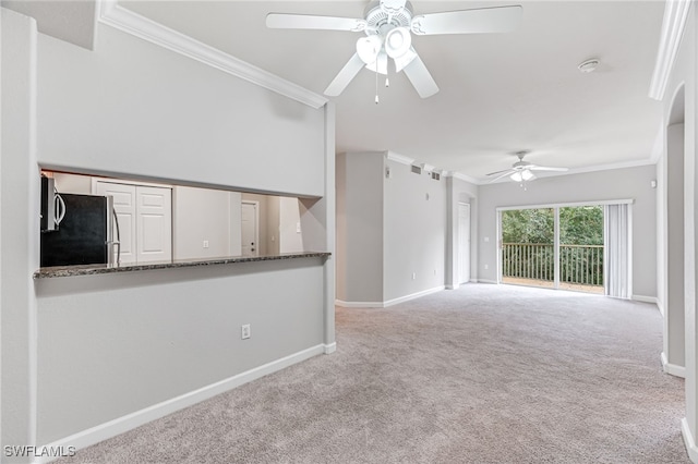 unfurnished living room featuring crown molding, ceiling fan, and light colored carpet