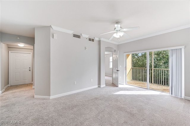 carpeted spare room featuring ceiling fan and ornamental molding