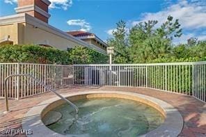 view of swimming pool with an in ground hot tub