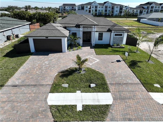 view of front of property featuring a garage and a front lawn