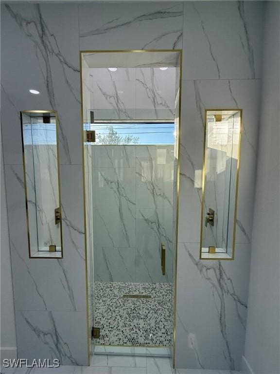 bathroom with a shower with door