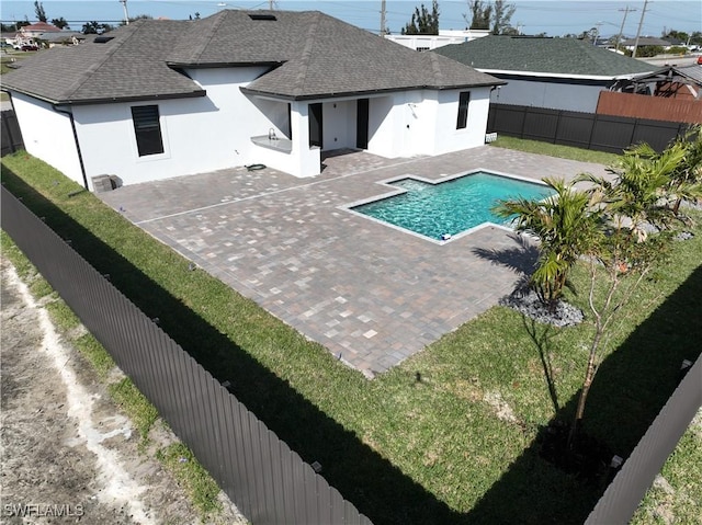 view of swimming pool with a patio area and a lawn