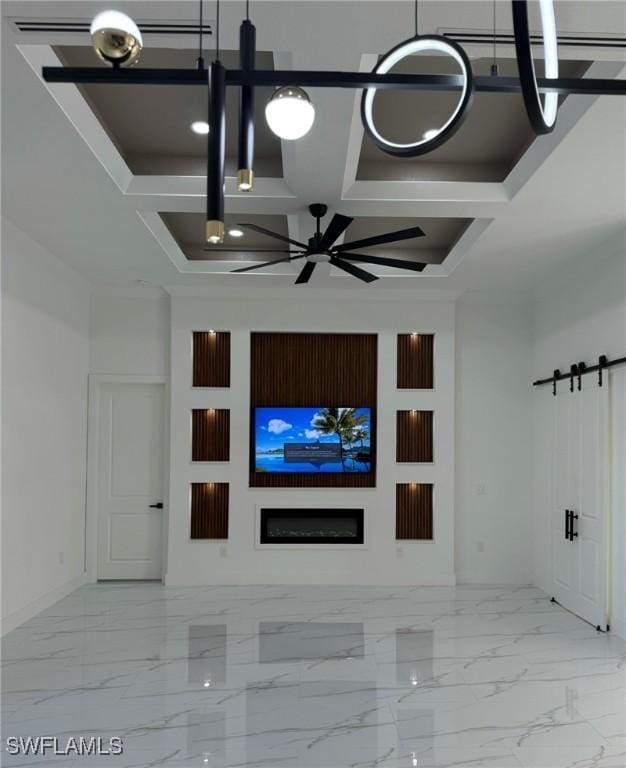 unfurnished living room featuring a barn door, coffered ceiling, and ceiling fan