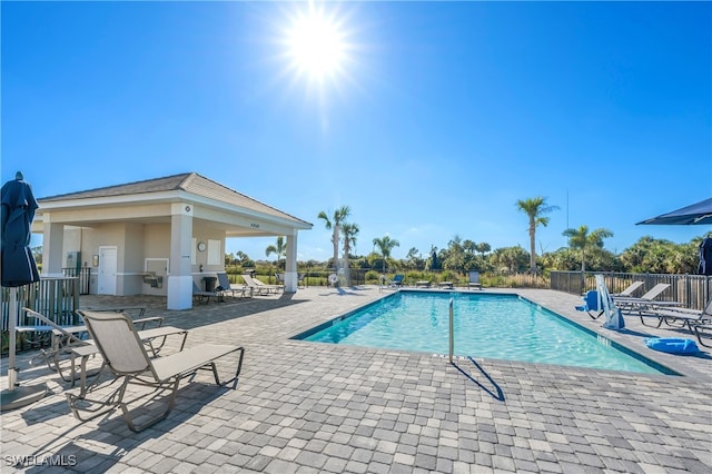 view of swimming pool featuring a patio area